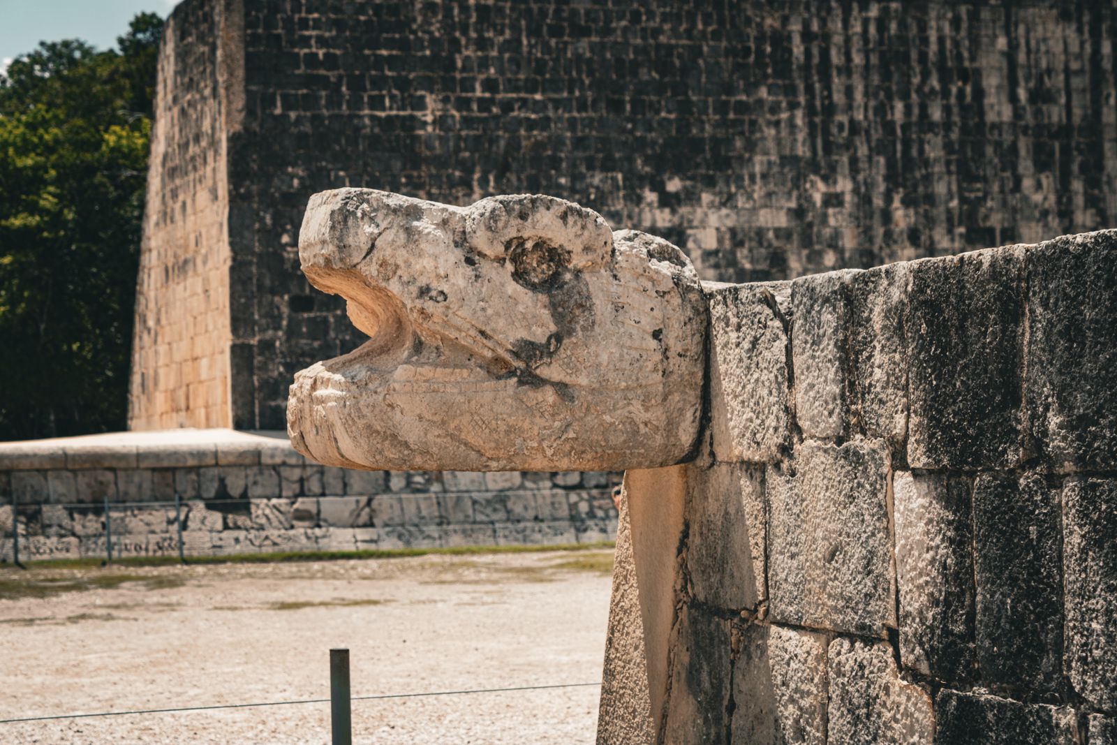 Feathered serpent stone carving on the steps of El Castillo